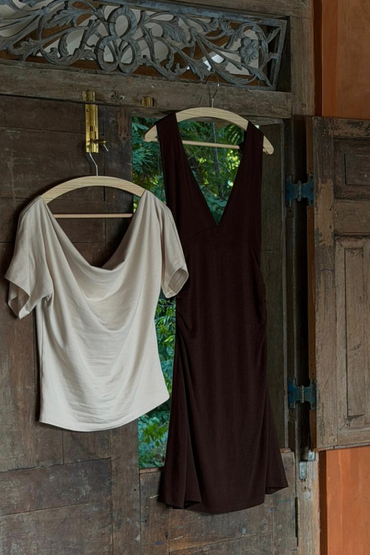 A halter-neck mini dress in a sustainable bamboo cotton stretch mix. Fitted through the torso with ruching at the waist to shape.