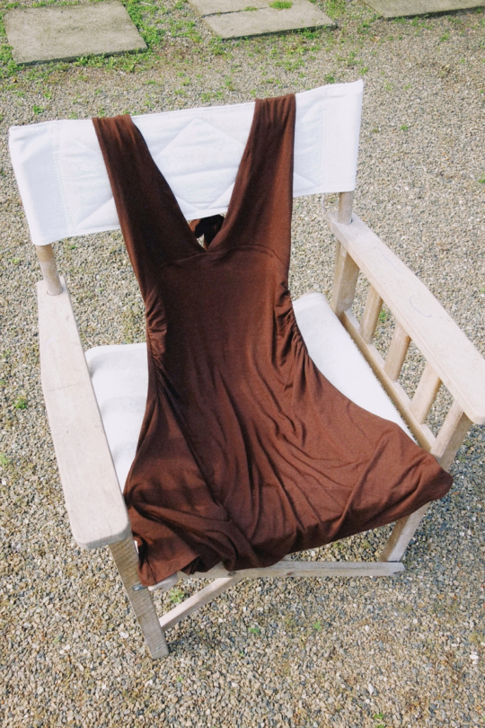 A halter-neck mini dress in a sustainable bamboo cotton stretch mix. Fitted through the torso with ruching at the waist to shape.