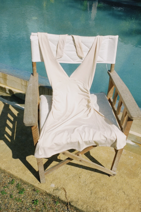 A halter-neck mini dress in a sustainable bamboo cotton stretch mix. Fitted through the torso with ruching at the waist to shape.