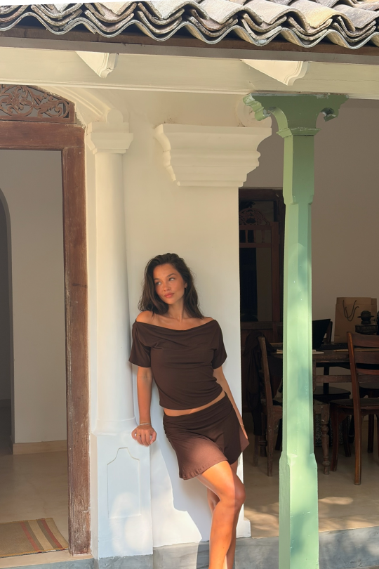 A short-sleeved blouse with flattering off-shoulder shaping across the shoulders.
