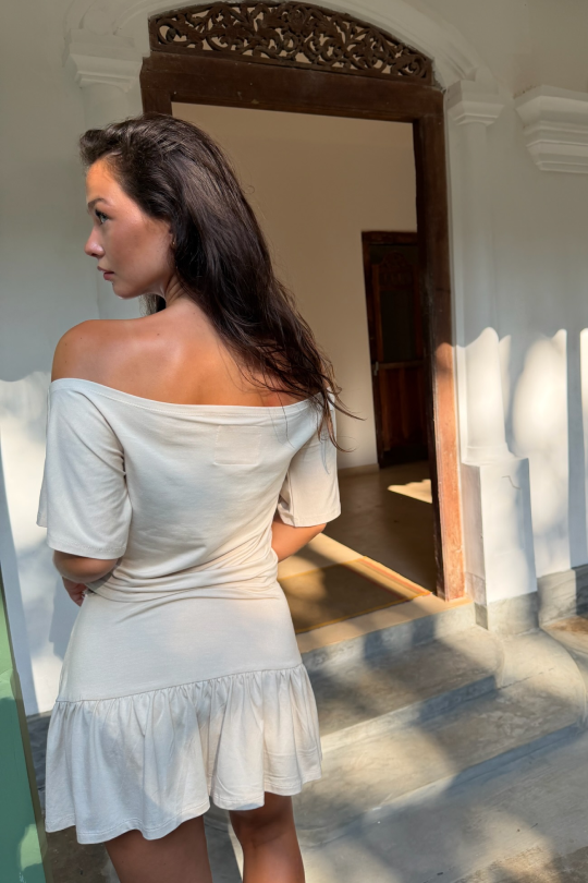 A short-sleeved blouse with flattering off-shoulder shaping across the shoulders.